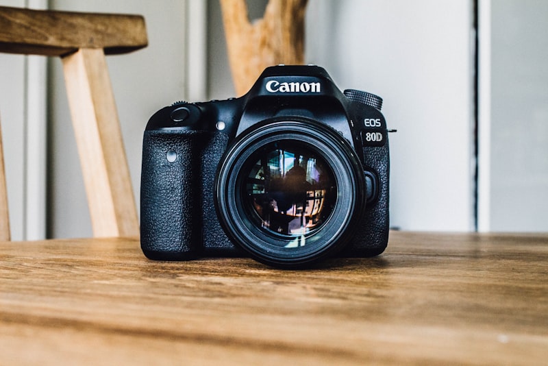 A camera lens resting on a flat surface with the front element facing up.