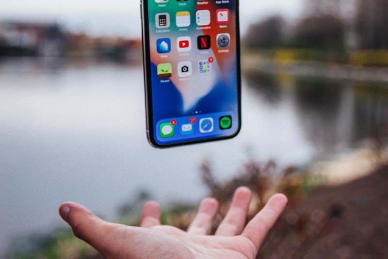 A person framing a photo on a smartphone screen outdoors.