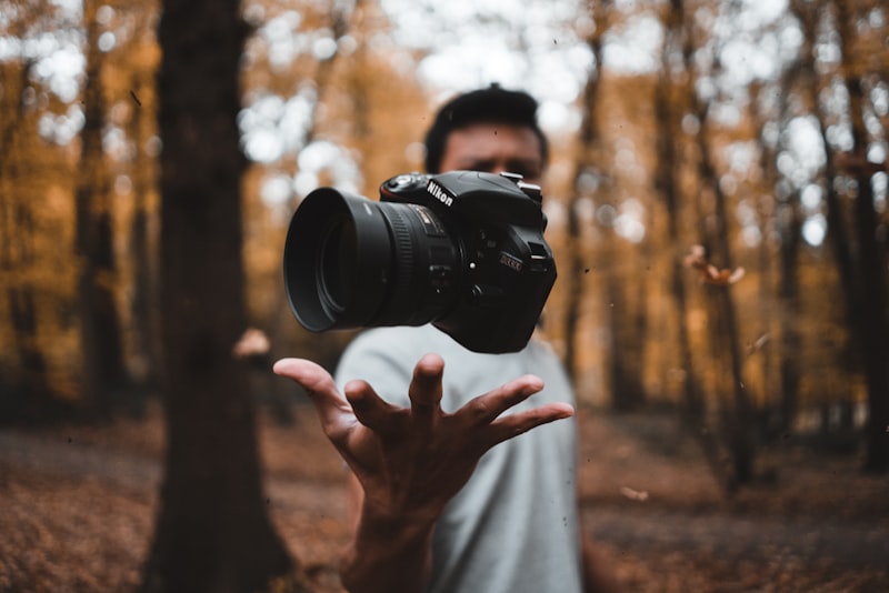 A camera lens being focused, with the focus ring in the foreground.